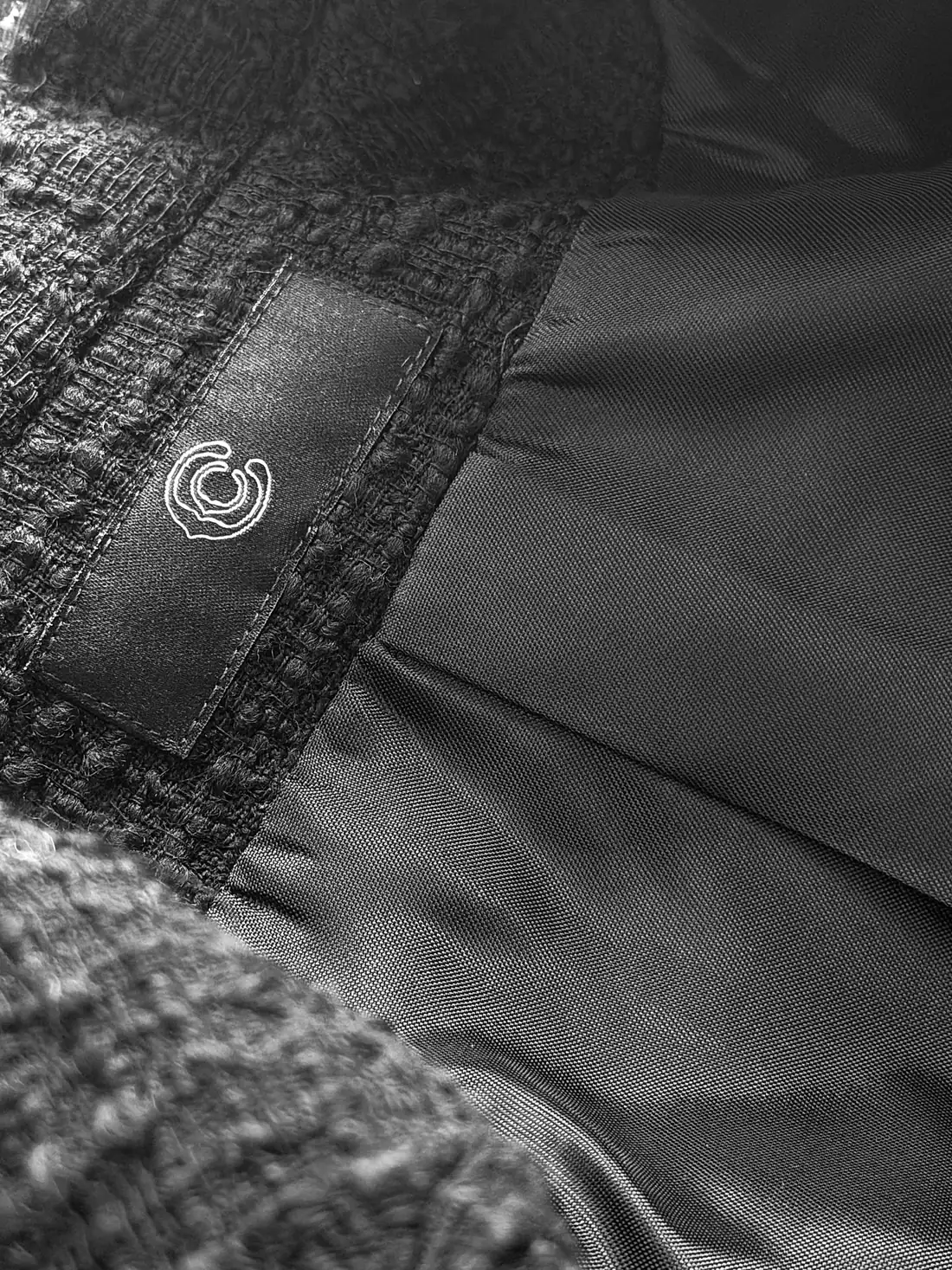The CC label stitched into the lining of a jacket.